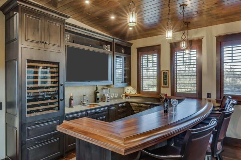 Custom bar in South Bend Indiana with seating area, tv, fridge, and sink