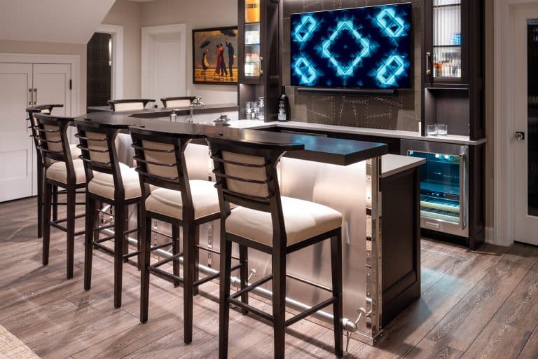 Basement bar with barstools and tv