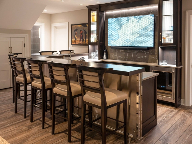 Basement bar with barstools and tv