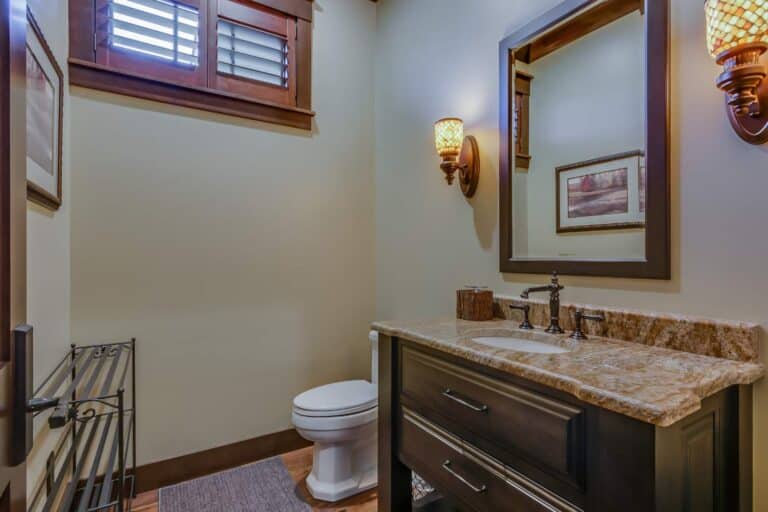 View of custom bathroom vanity, toilet, mirror and sink in South Bend Indiana