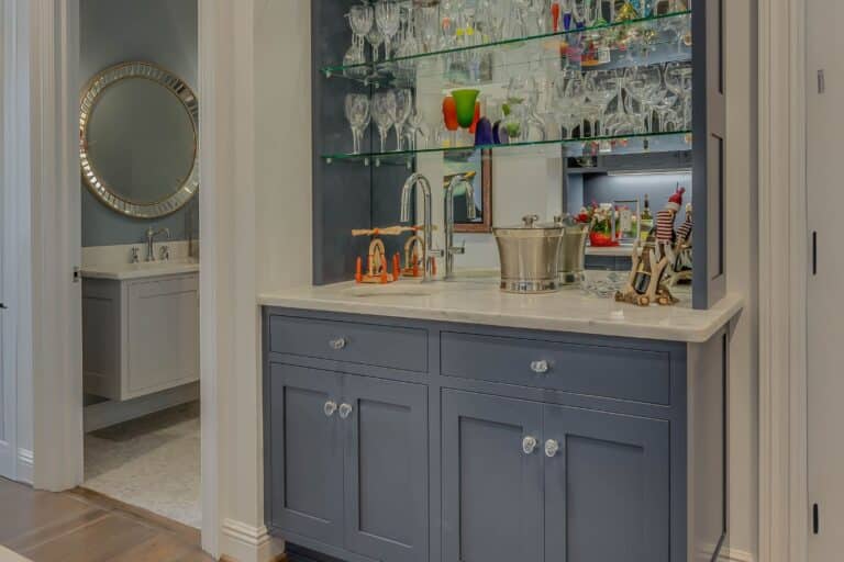 Custom wet bar with glass shelves and cabinets in Granger IN