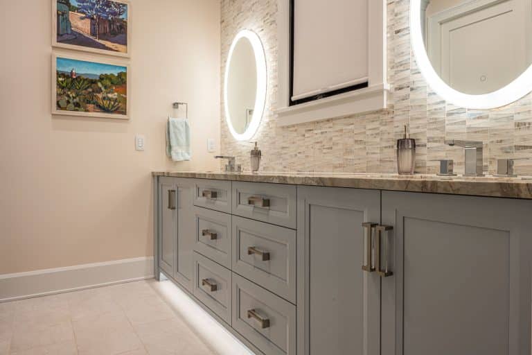 Grey bathroom vanity with sinks and mirrors