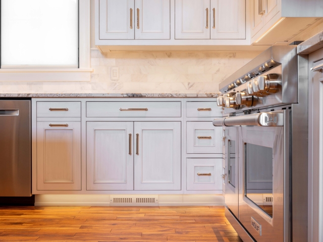 Gray inset kitchen cabinets and oven