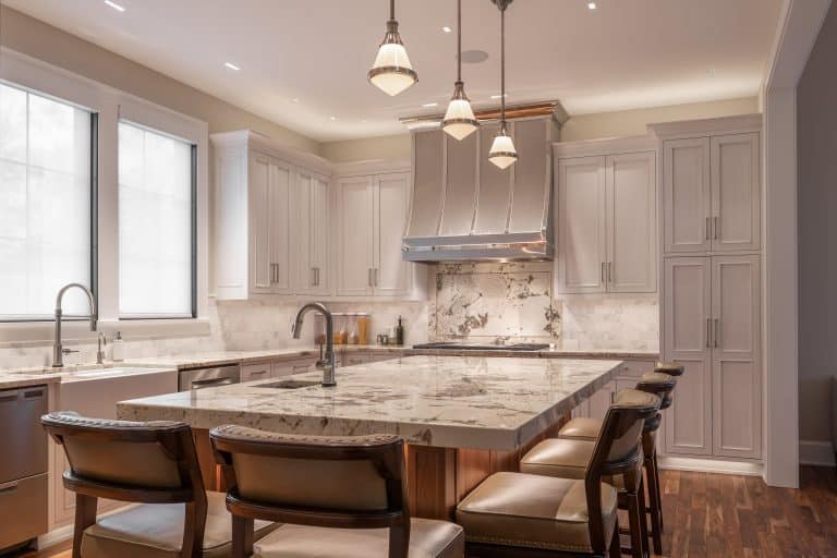 Gray inset kitchen cabinets with marble countertop island