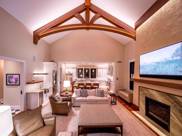 Wooden truss on vaulted ceiling above living room