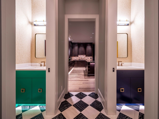 Bathroom with two sinks with a doorway into a kitchen