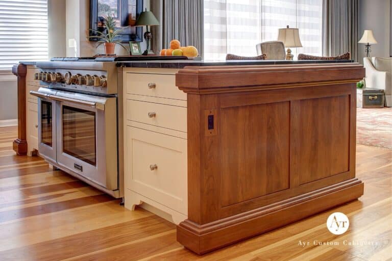 Corner of kitchen Island with stove, drawers, and island trim visible