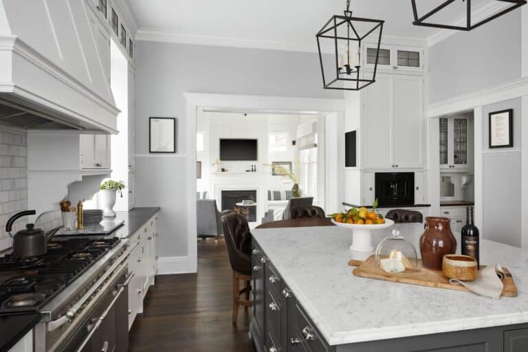 Custom kitchen in Evanston Illinois with white cabinets, gray island, and black framed lighting