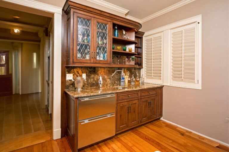 Custom wet bar in South Bend INdiana with view of glass cabinets and display shelves